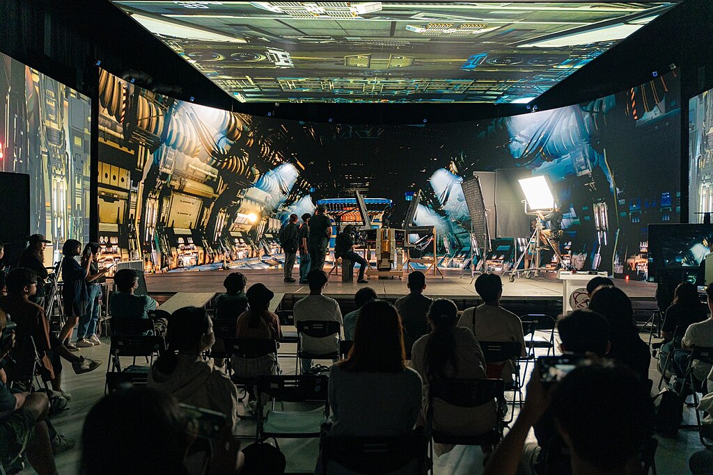 Virtual production stage with LED walls and crew during filming
