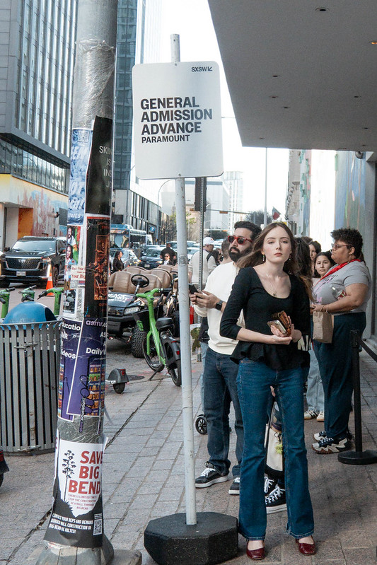 Young woman waiting in line at an event during the 2026 SXSW festival in Austin, Texas