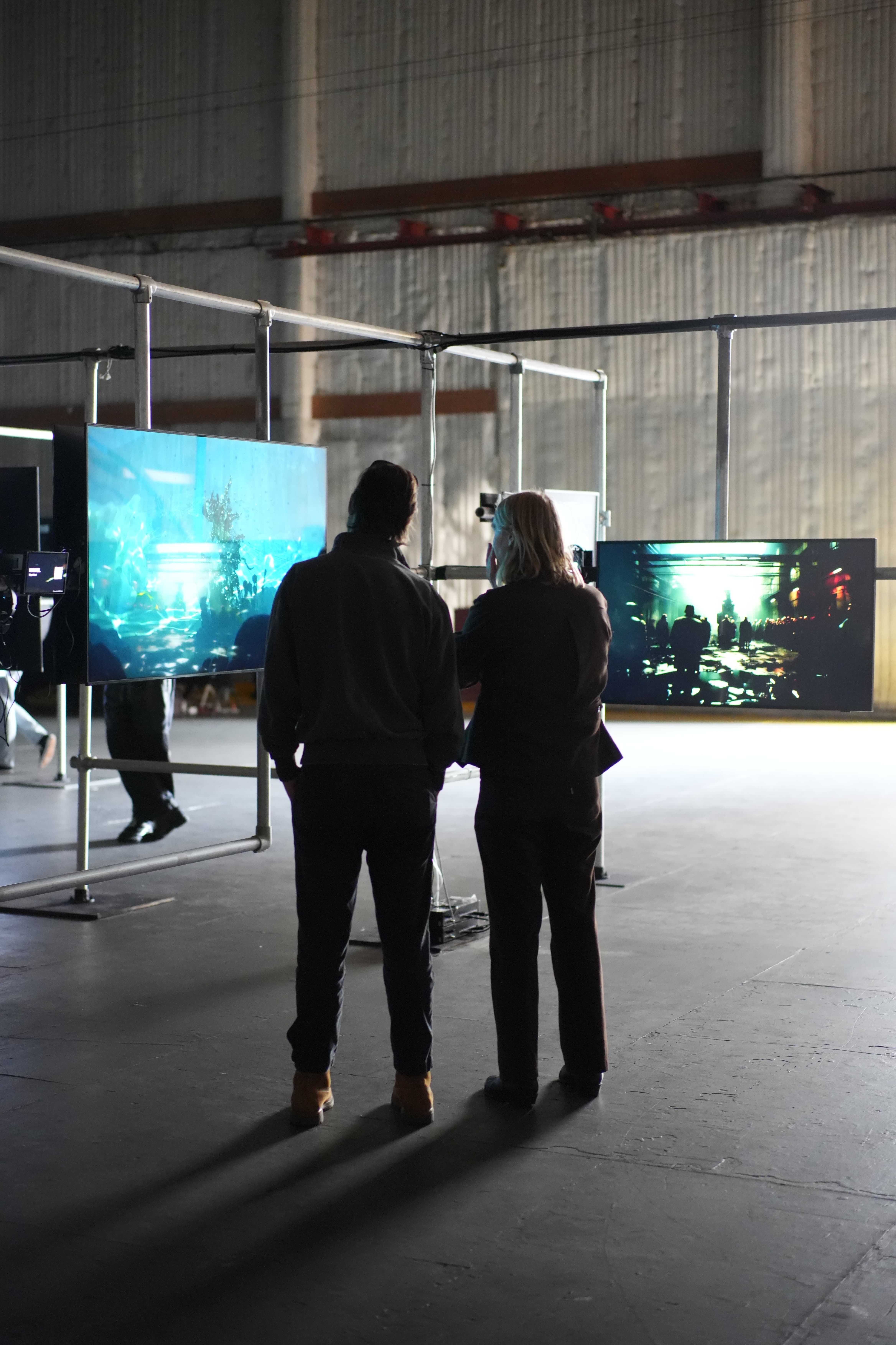 Attendees viewing works in the generative art gallery at AI on the Lot 2024