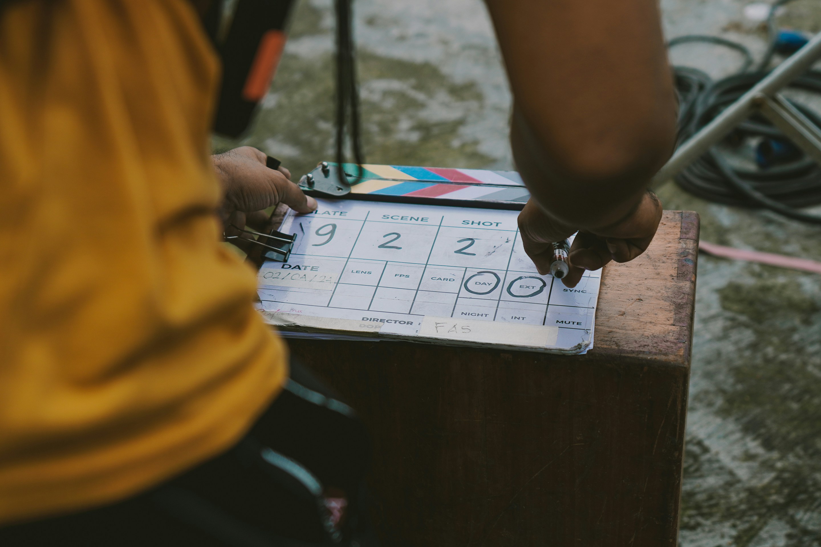 Close-up of clapperboard on set representing practical workflows