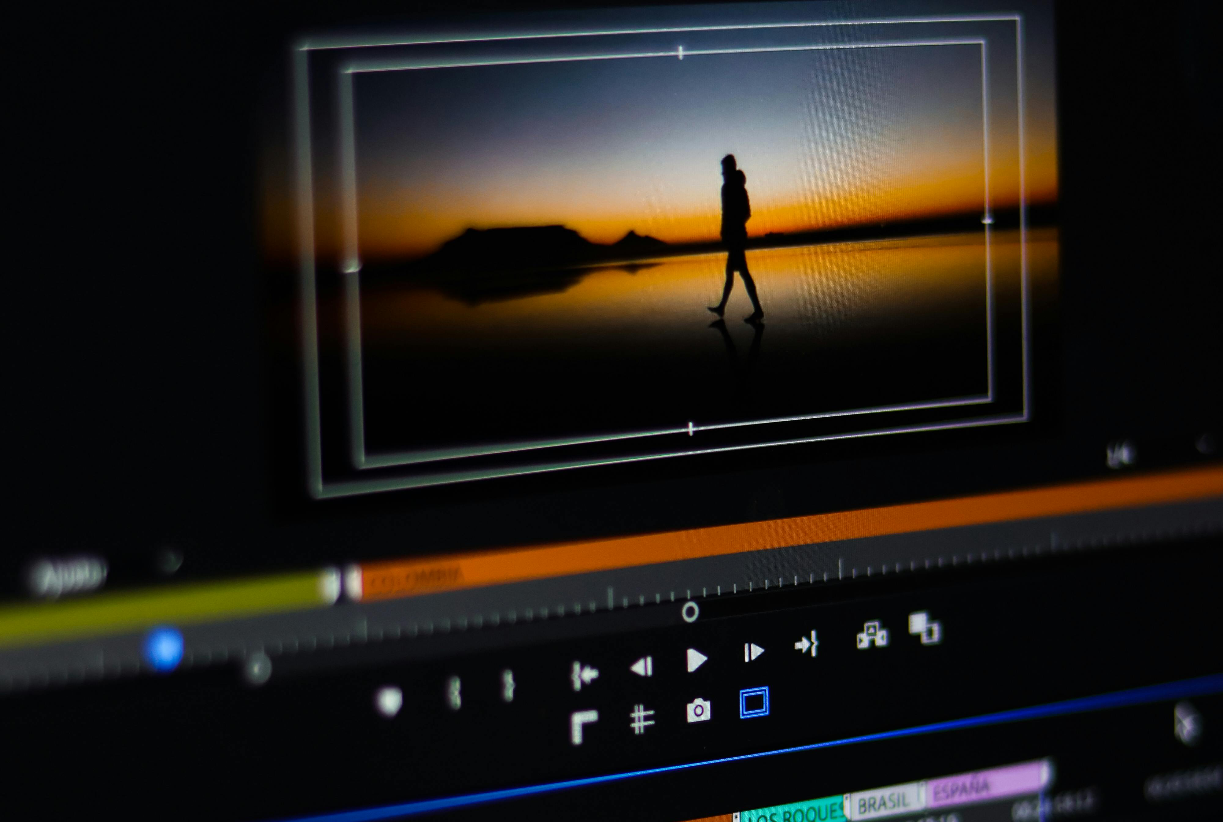AI-assisted video editing interface with timeline and waveforms on a computer screen (Pexels License)