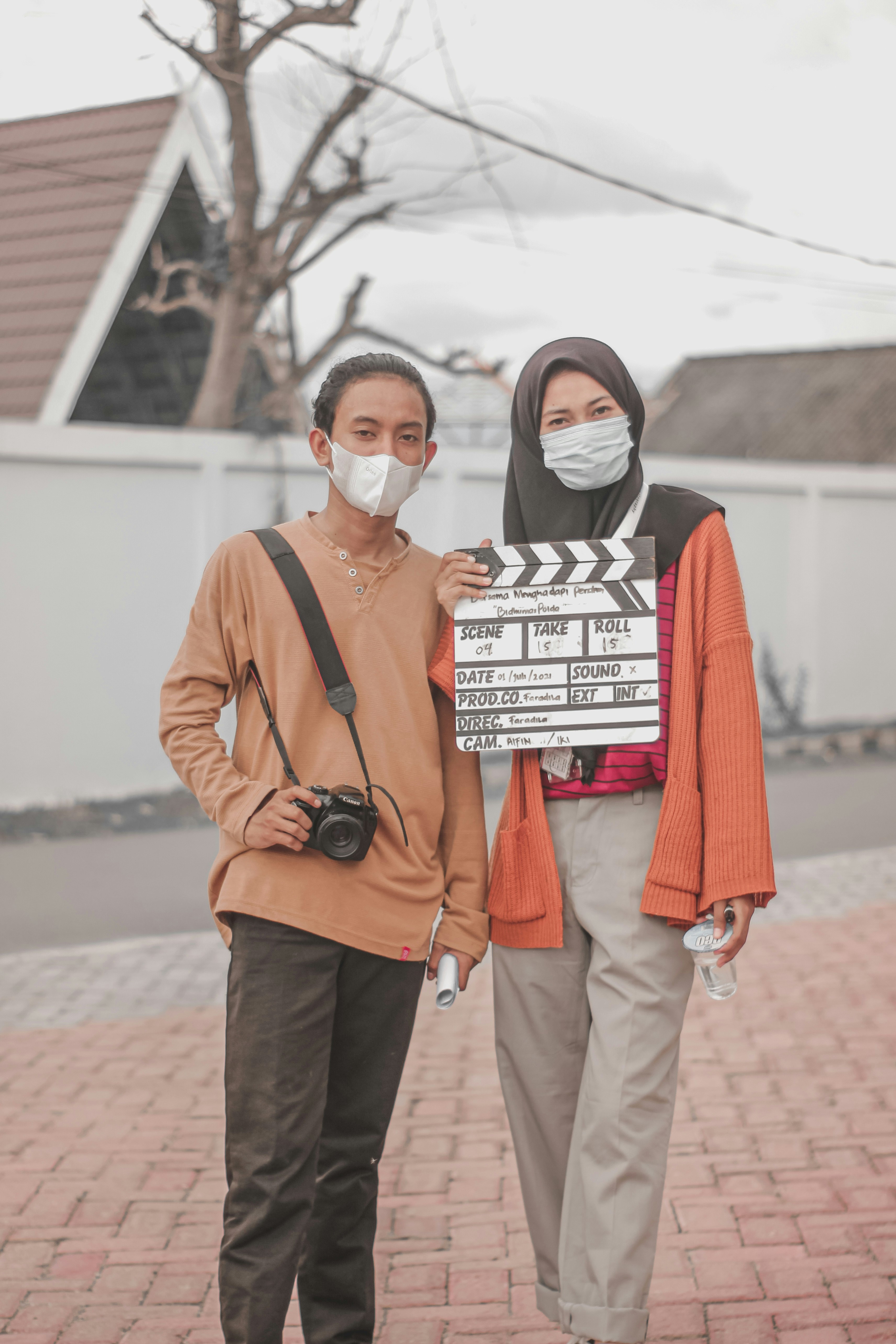 Young Indonesian filmmakers holding a clapperboard