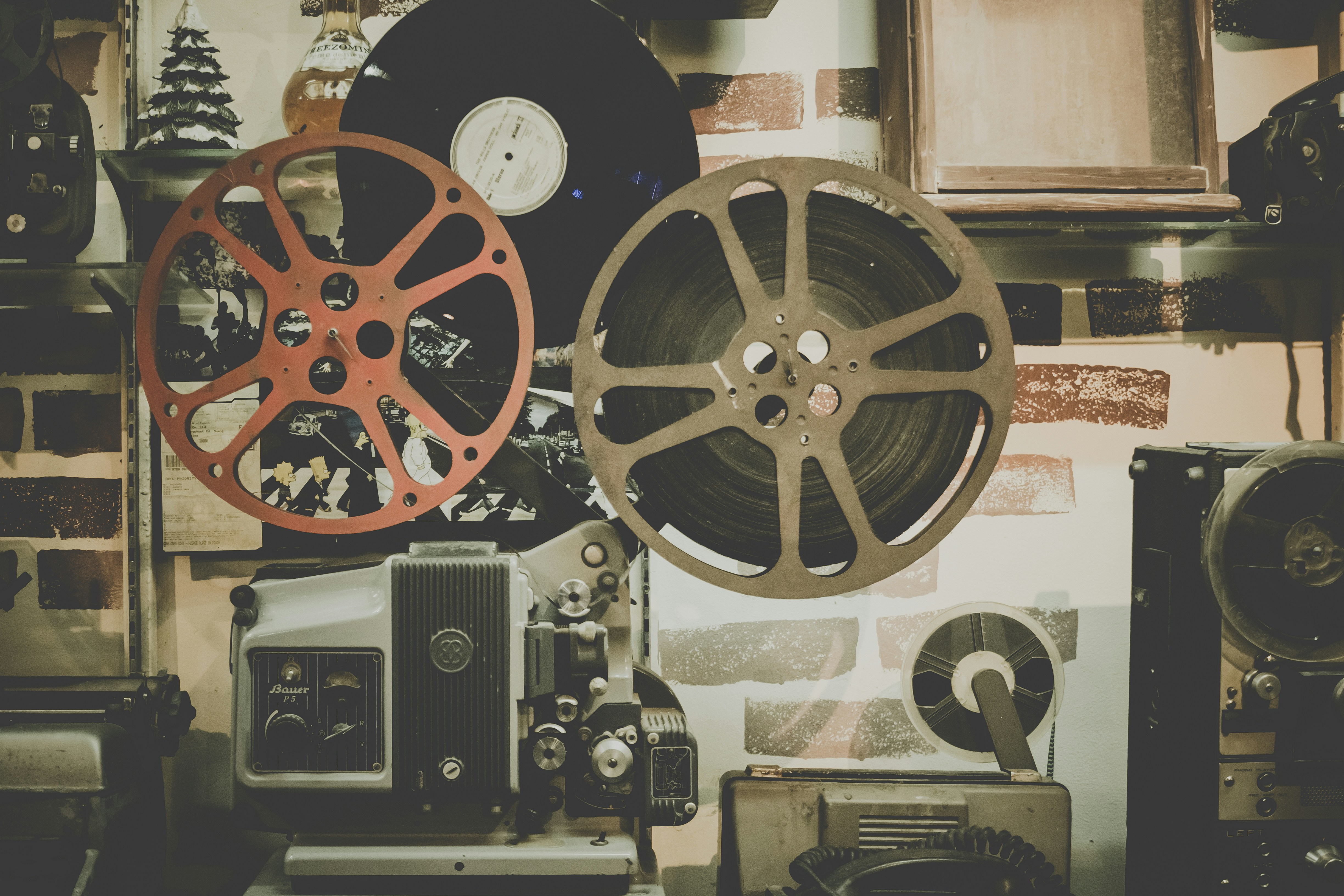 Two film reels sitting on a wooden surface representing the vast library of content