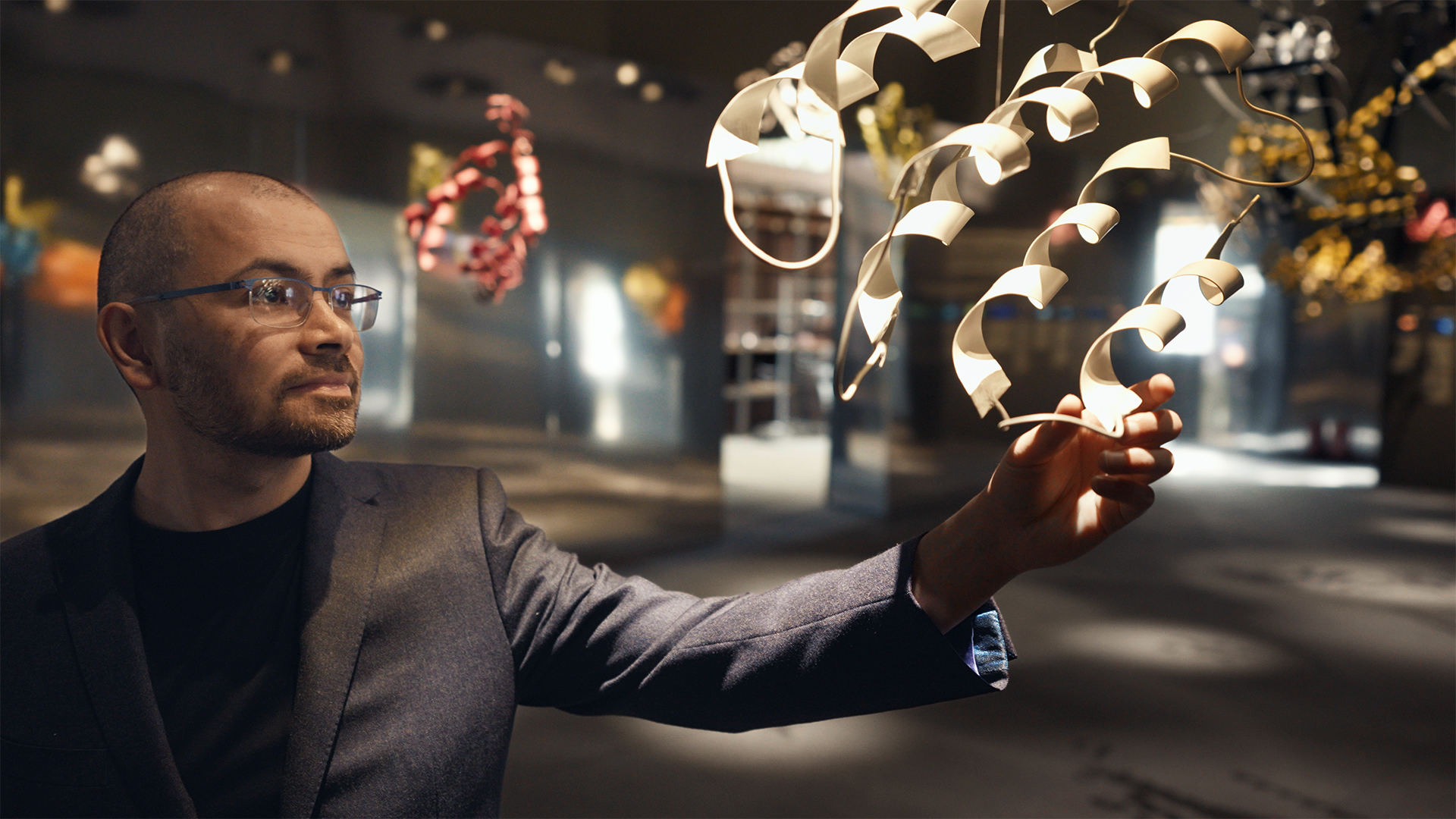 Demis Hassabis examining protein structure visualization at DeepMind