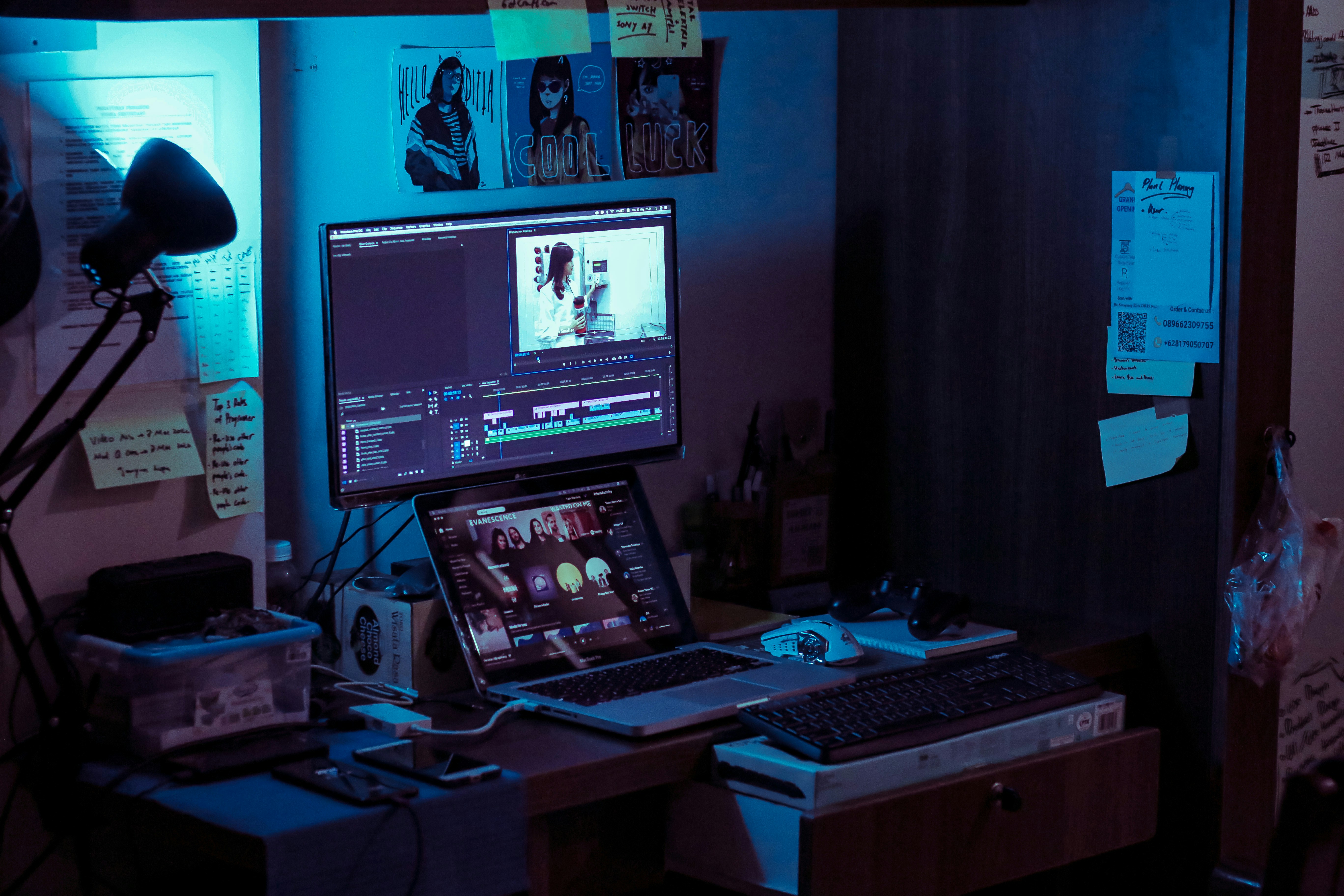 Video editing workstation with multiple screens showing production workflow